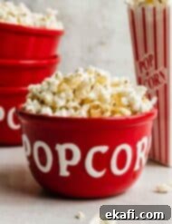 Sweet and Salty Kettle Corn 7 Kettle Corn Popcorn in a red bowl against a gray background.