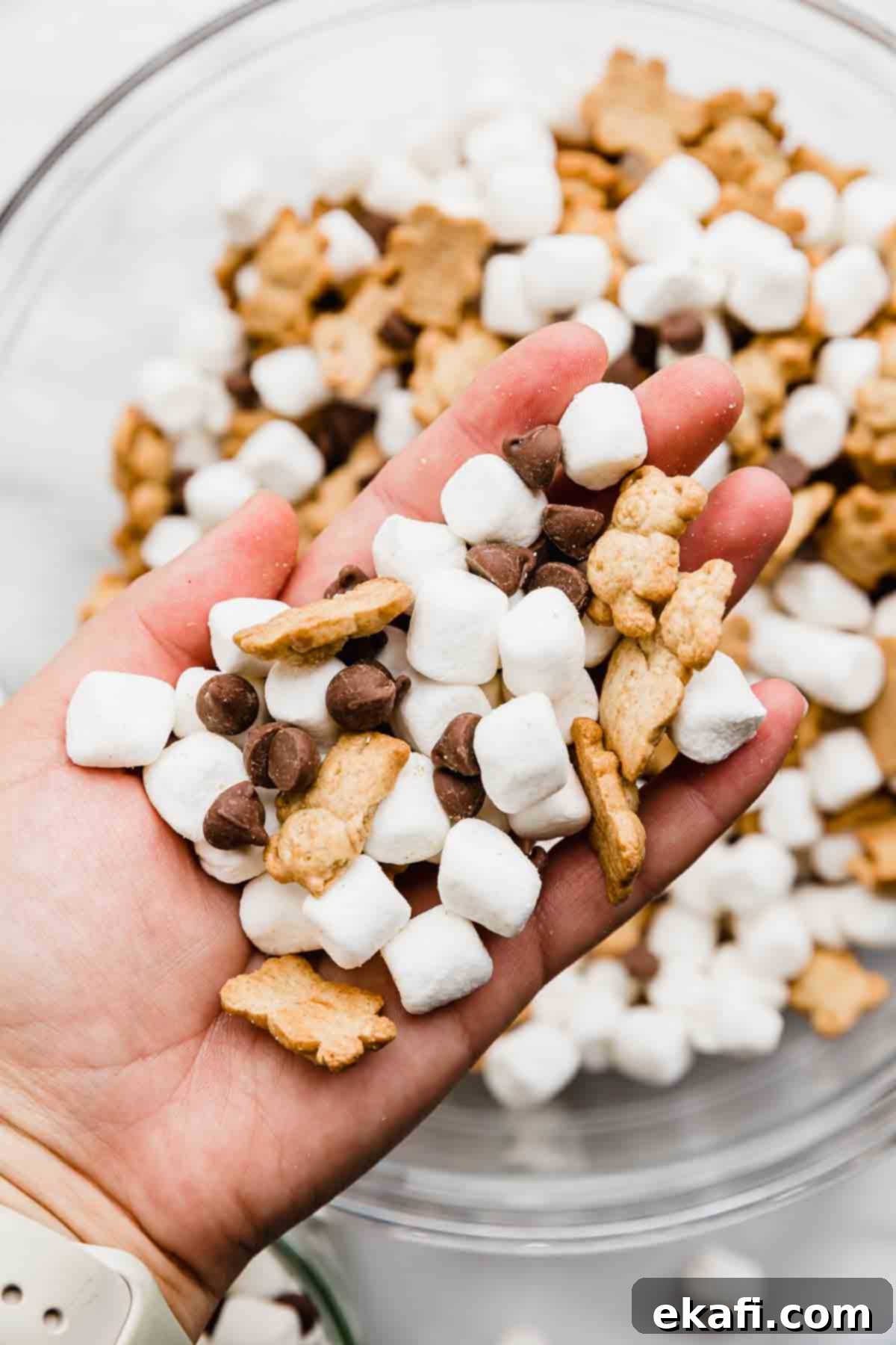 S'mores Mix 6 A hand holding S'mores snack mix.