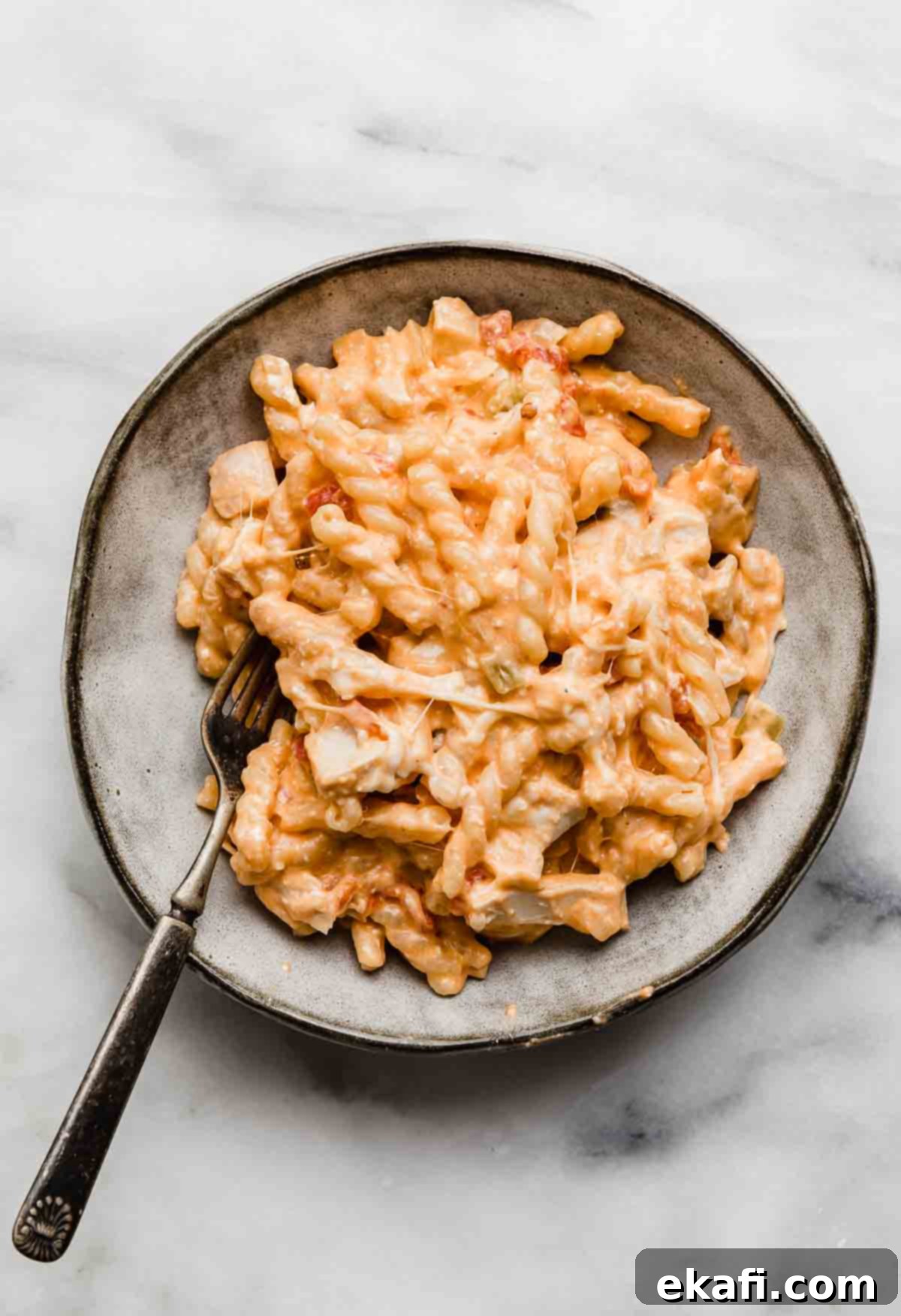 Ultimate Buffalo Chicken Pasta 6 A gray bowl with Buffalo Chicken Pasta, on a white marble background.