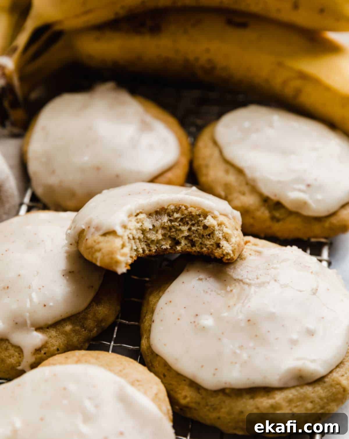 Sweet Frosted Banana Cookies 6 A bite taken out of a banana cookie frosted with brown butter frosting.