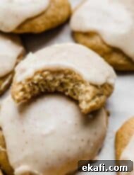 Sweet Frosted Banana Cookies 7 Frosted Banana Cookies with one cookie having a bite taken out of it.