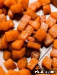Cinnamon-Kissed Roasted Butternut 3 Close-up of Cinnamon Roasted Butternut Squash in a bowl.