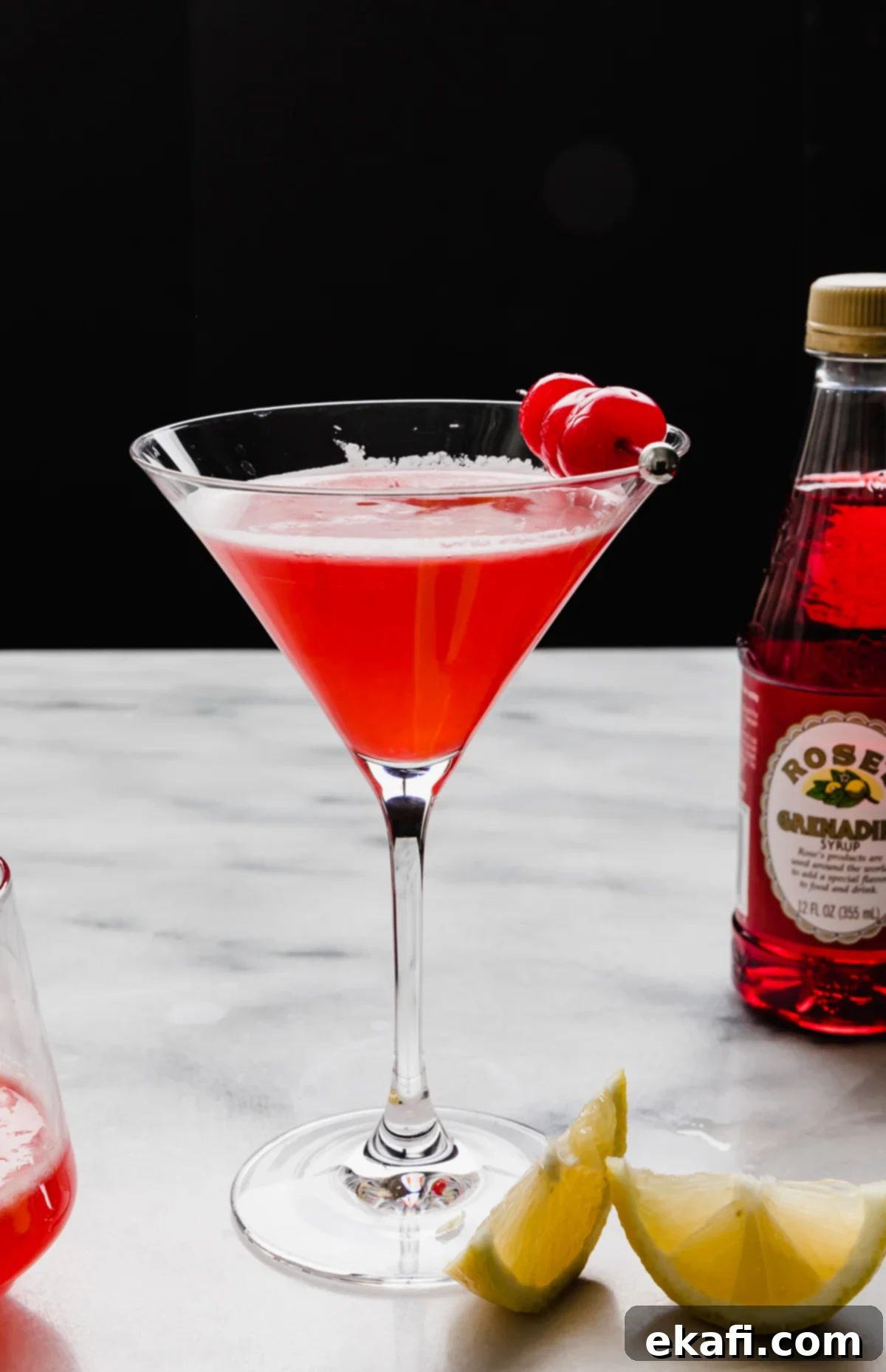 Pink Lady Bliss 6 A pink lady cocktail without alcohol in a martini glass against a black background.