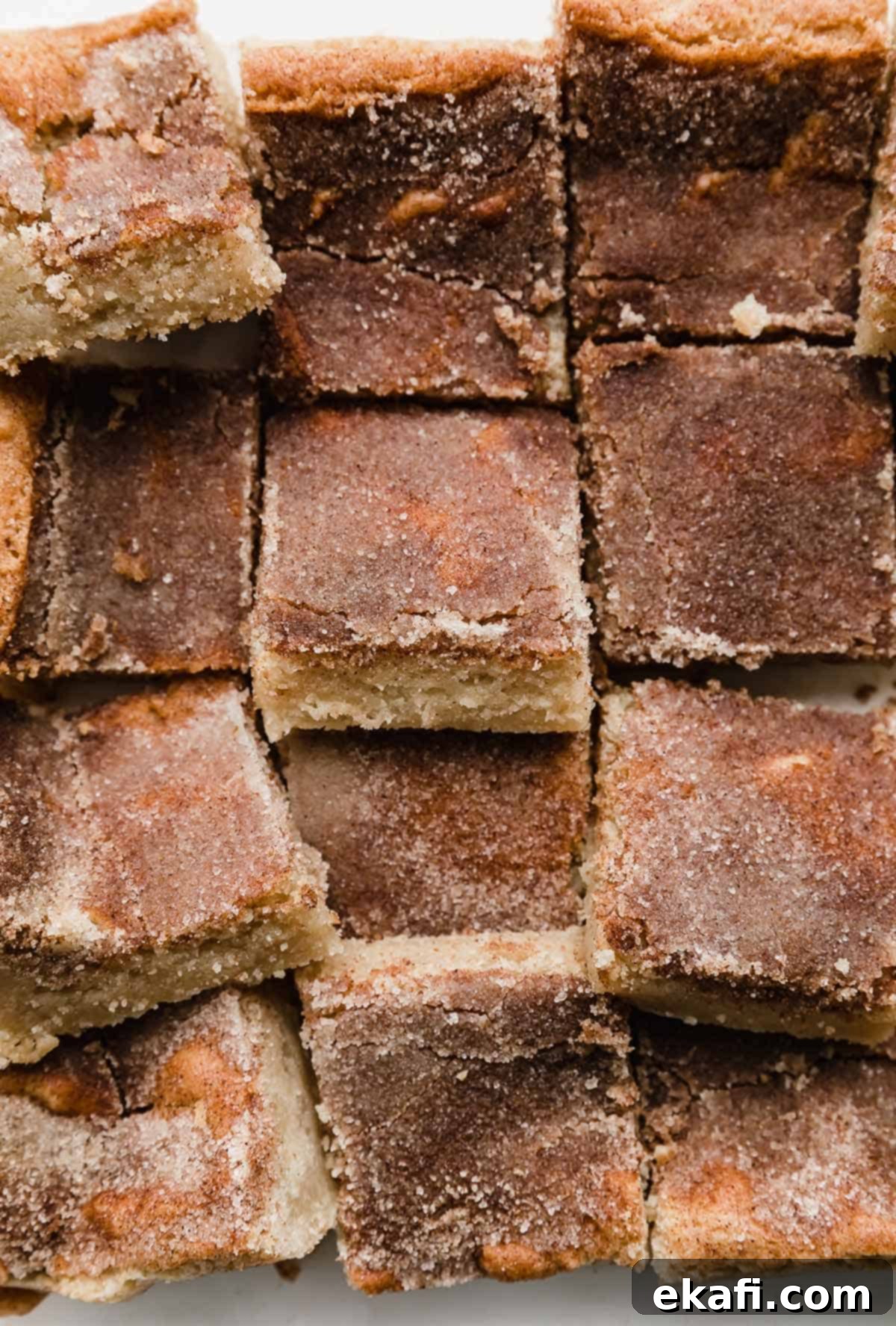 Chewy Snickerdoodle Blondies 6 Snickerdoodle Bars recipe topped with cinnamon sugar and cut into squares.