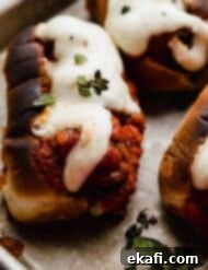 Classic Italian Meatball Subs 7 The best Italian Meatball Subs topped with melted cheese, on a baking sheet.