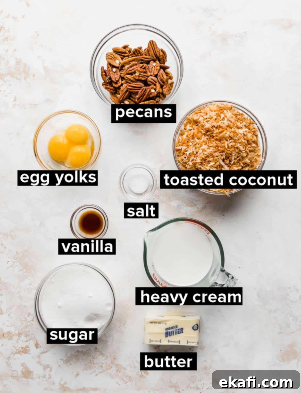 Decadent German Chocolate Ice Cream 4 Ingredients used to make coconut pecan frosting, on a white textured background.