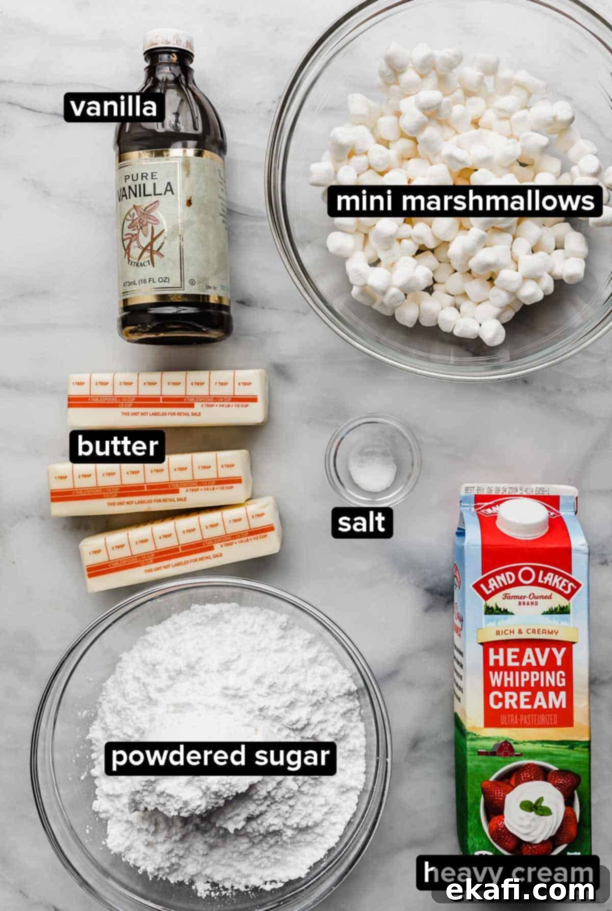 Καβουρδισμένο Μαρσμάλοου Γλάσο 3 Toasted Marshmallow Frosting ingredients on a white surface: heavy cream, mini marshmallows, powdered sugar, butter, and vanilla extract.