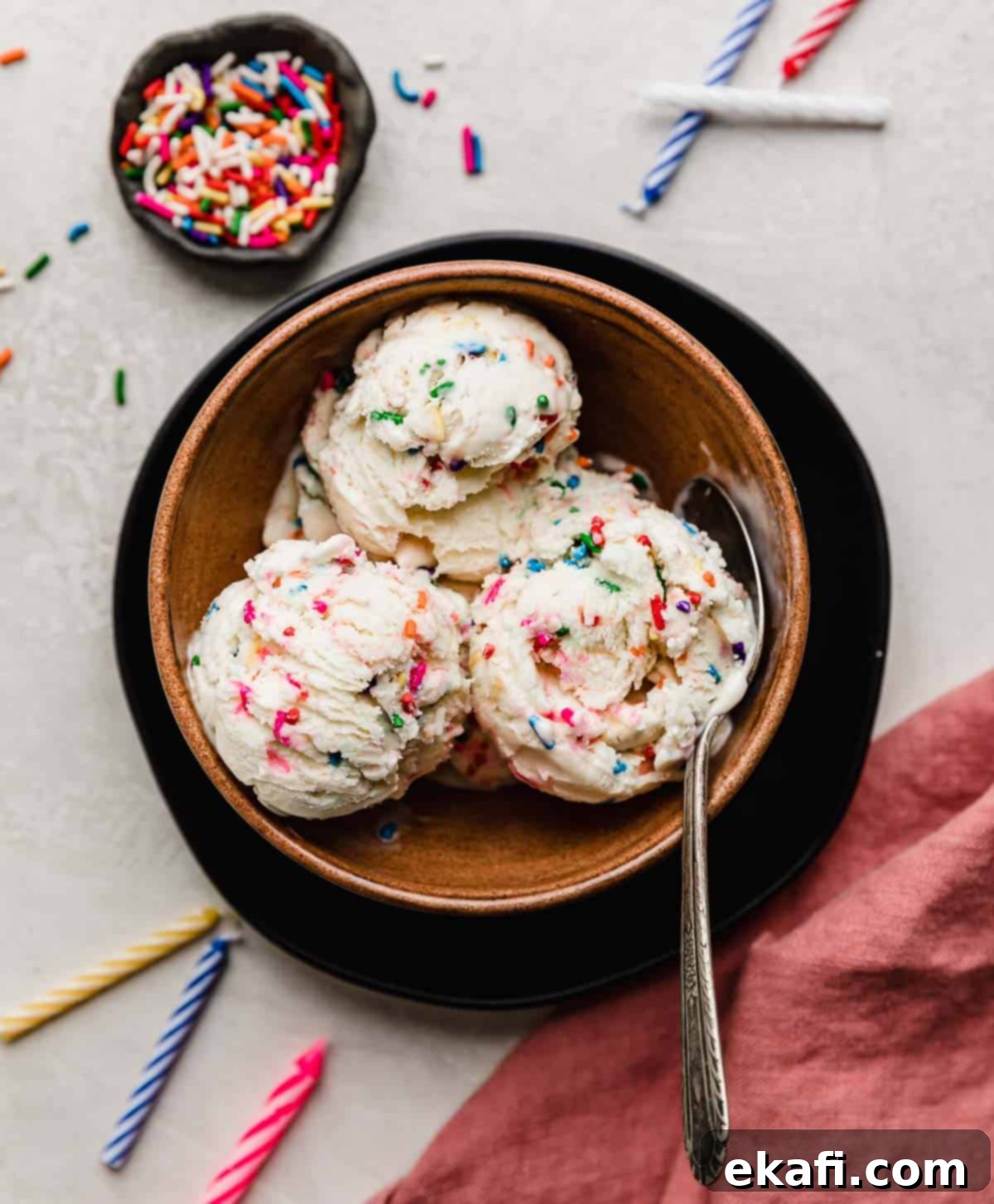 Confetti Cake Ice Cream 7 Sprinkle ice cream with cake mix scooped into a brown bowl on a white background.