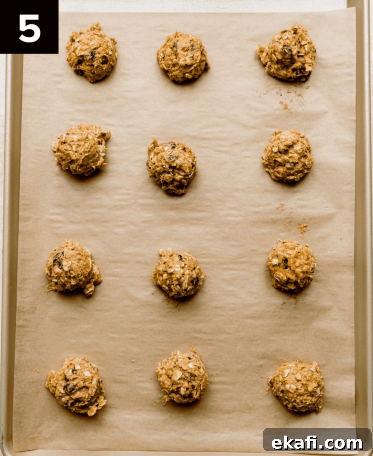 Cozy Pumpkin Chocolate Chip Oatmeal Delights 5 Chocolate Chip Oatmeal Pumpkin Cookie dough balls perfectly spaced on a baking sheet, ready for the oven.