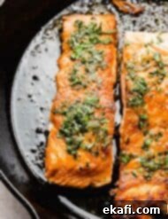 Sweet and Zesty Glazed Salmon 6 Seared Lemon Honey Glazed Salmon in a black skillet, beautifully plated and ready to eat.