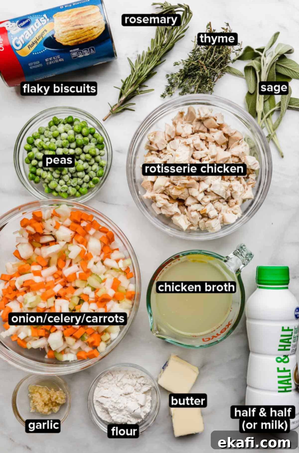 Cast Iron Chicken Pot Pie 3 Cast Iron Chicken Pot Pie ingredients on a white marble surface: onion, carrot, celery, rosemary, thyme, sage, butter, chicken broth, flour, peas, chicken, and milk (half and half).