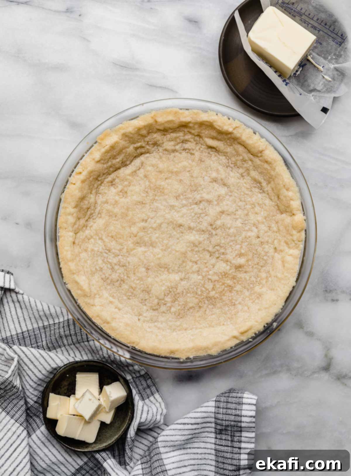 Buttery Shortbread Pie Base 2 The best Shortbread Pie Crust recipe baked in a 9" pie plate on a white marble surface.