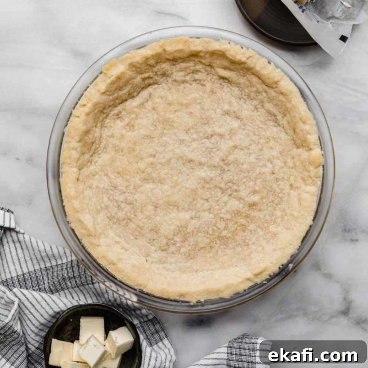 Buttery Shortbread Pie Base 7 Shortbread Pie Crust baked in a 9" round pie plate on a light gray marbled surface.