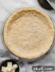 Buttery Shortbread Pie Base 8 Shortbread Pie Crust baked in a 9" round pie plate on a light gray marbled surface.