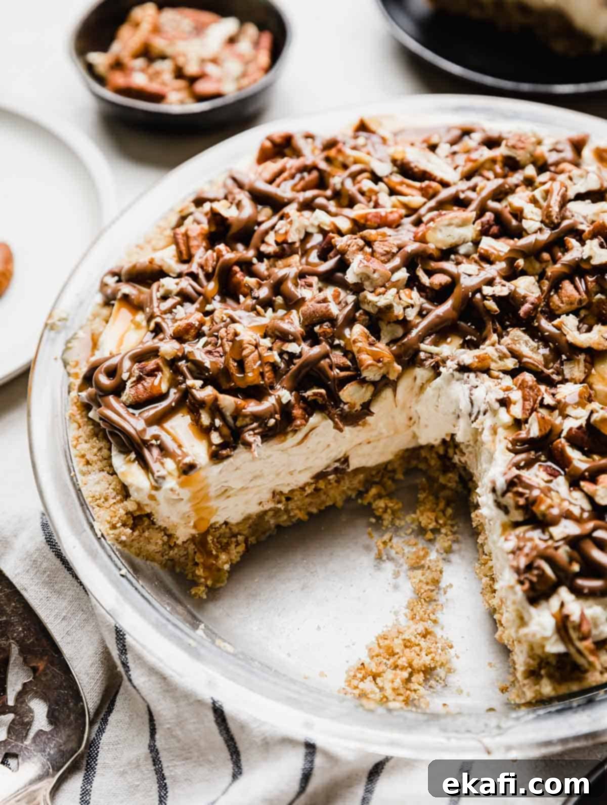 Caramel Pecan Utopia 2 A Turtle Pie recipe in a 9" pie plate with a pecan graham cracker crust, caramel cheesecake layer and chocolate caramel and pecan topping.