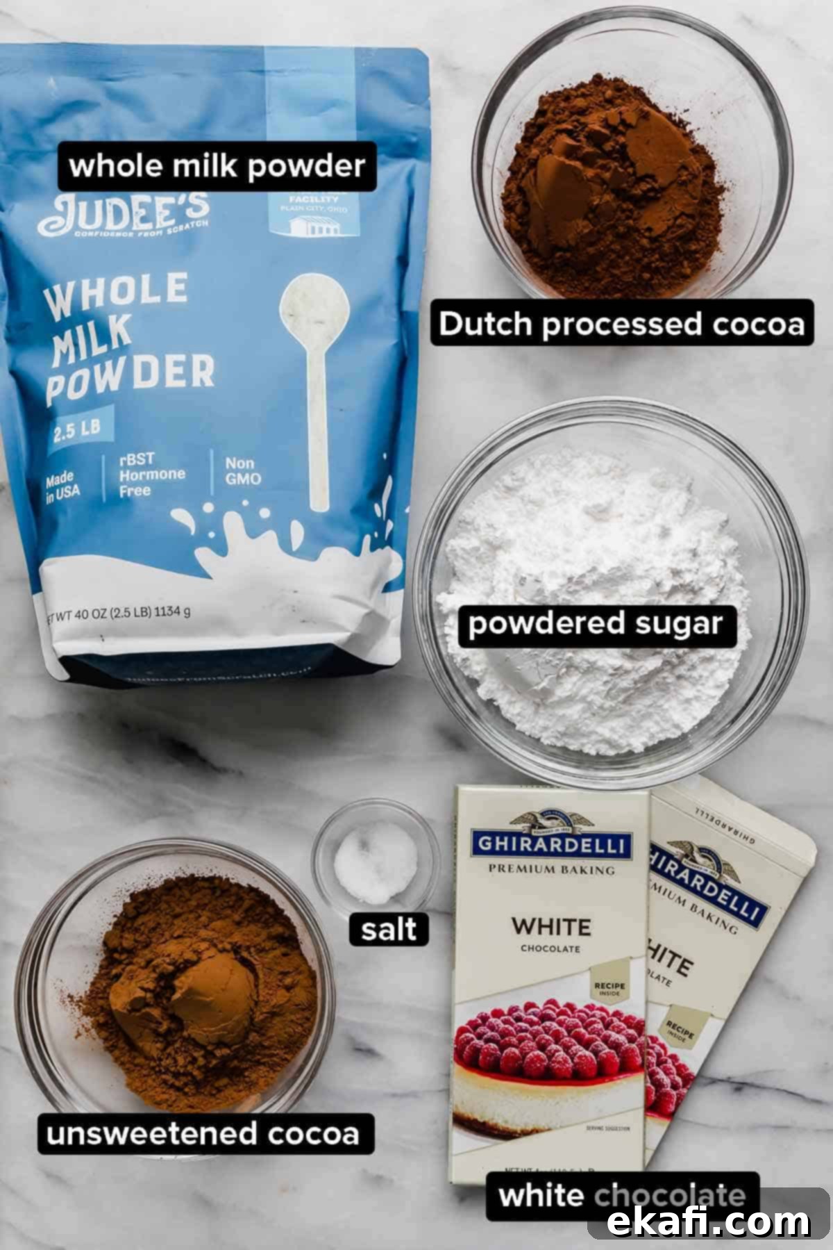 Homemade Hot Chocolate Delight 3 Ingredients used to make Homemade Hot Cocoa Mix (homemade hot chocolate) on a white marble surface: whole milk powder, cocoa powders, white chocolate, salt, and powdered sugar.