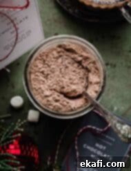Homemade Hot Chocolate Delight 7 Overhead photo of homemade hot chocolate mix in a jar with a spoon in it.
