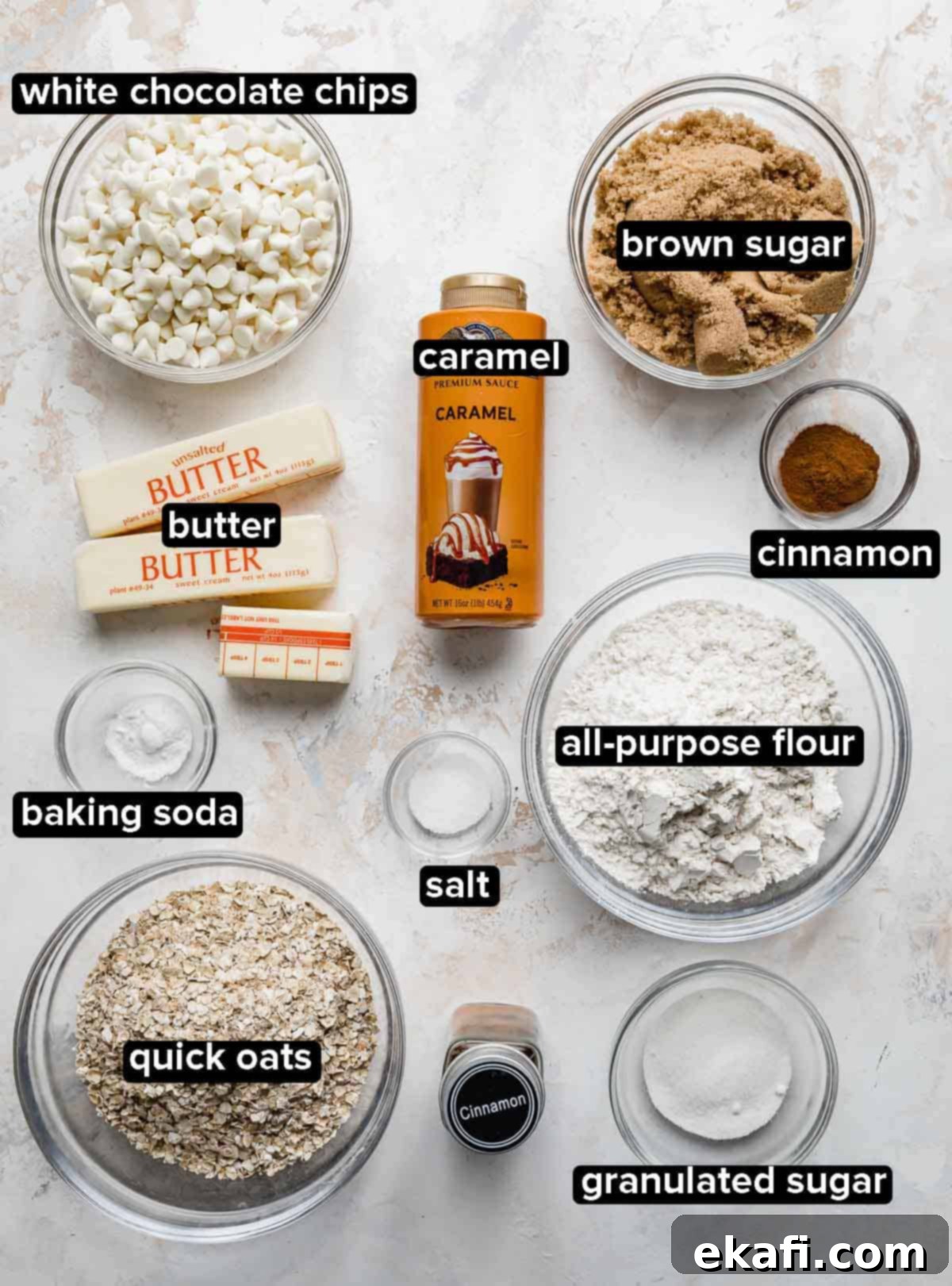 Golden Caramel Chews 3 Cinnamon Sugar Caramelitas ingredients portioned into glass bowls on a white background, including flour, oats, brown sugar, cinnamon, butter, white chocolate chips, and caramel sauce.