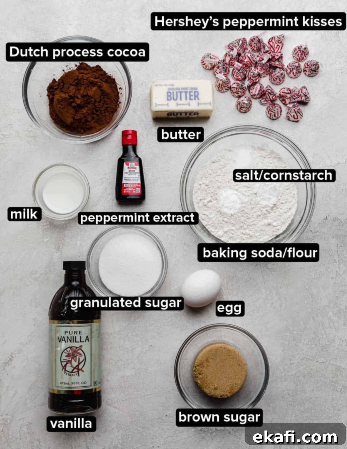 Peppermint Kissed Chocolate Gems 3 Chocolate Peppermint Blossom cookies ingredients on a light gray background: cocoa, sugars, egg, butter, Hershey's kisses, and peppermint extract.