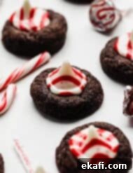 Peppermint Kissed Chocolate Gems 8 A chocolate cookie topped with a red and white striped Hershey's peppermint kiss.
