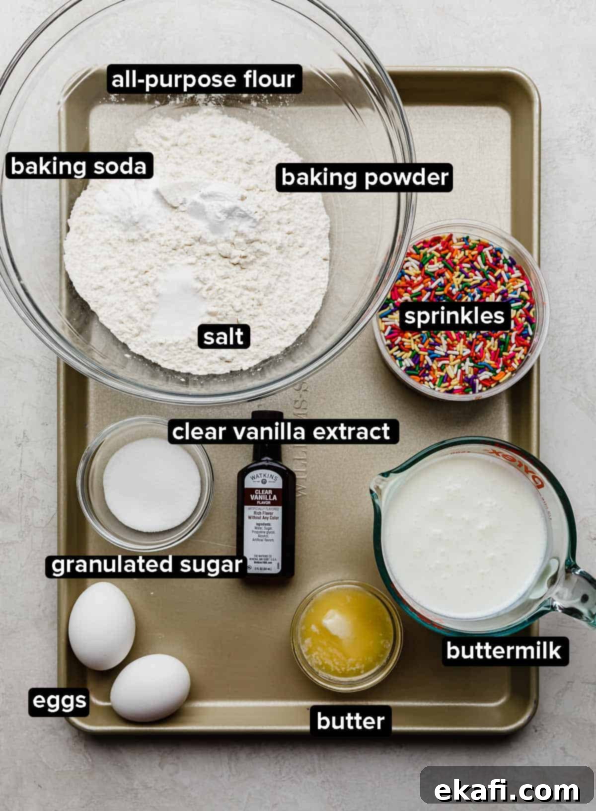 Confetti Morning Cakes 3 Birthday Cake Pancake ingredients on a gold baking sheet.