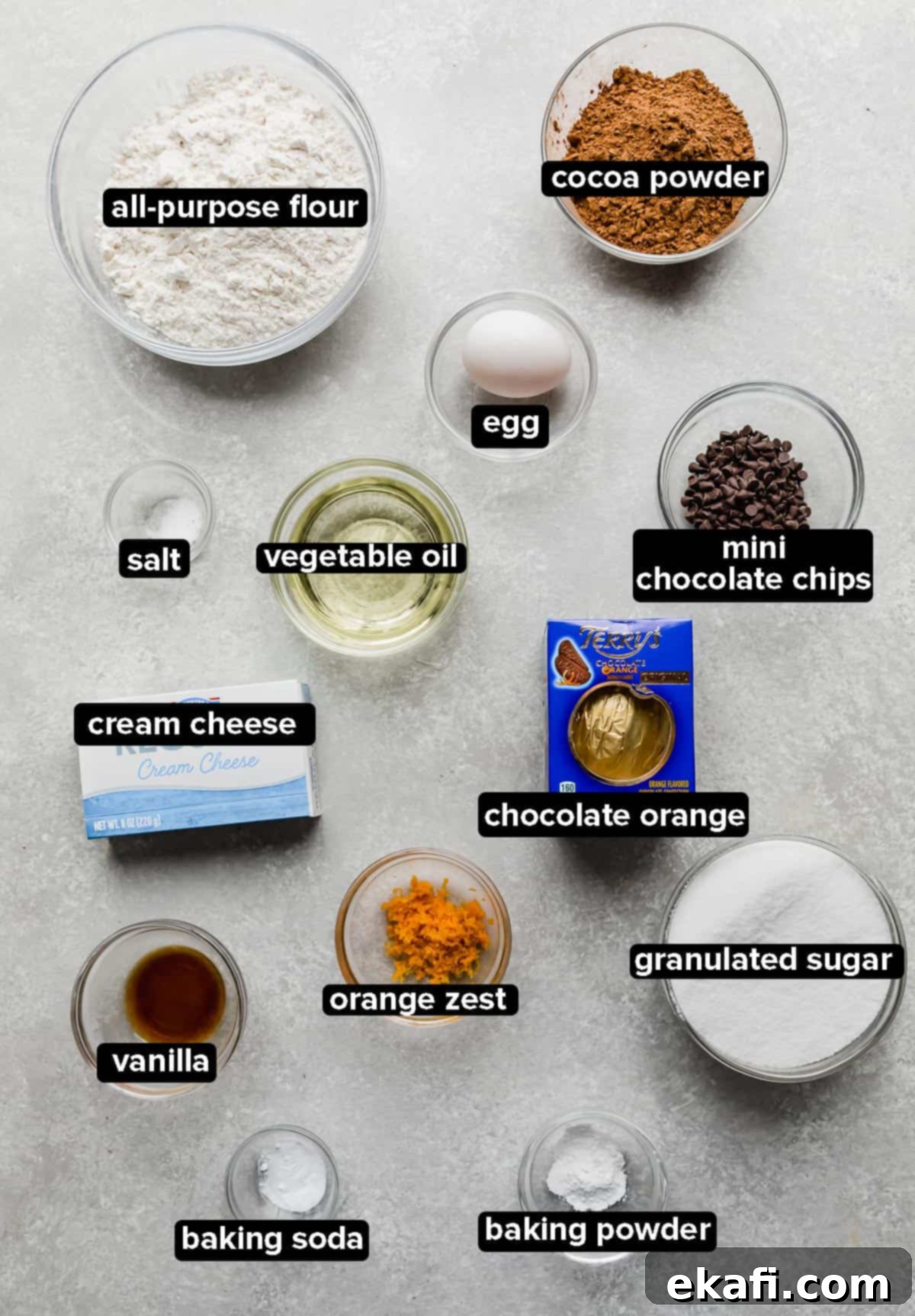 Irresistible Chocolate Orange Cookies 3 Chocolate Orange Cookie ingredients on a gray background.