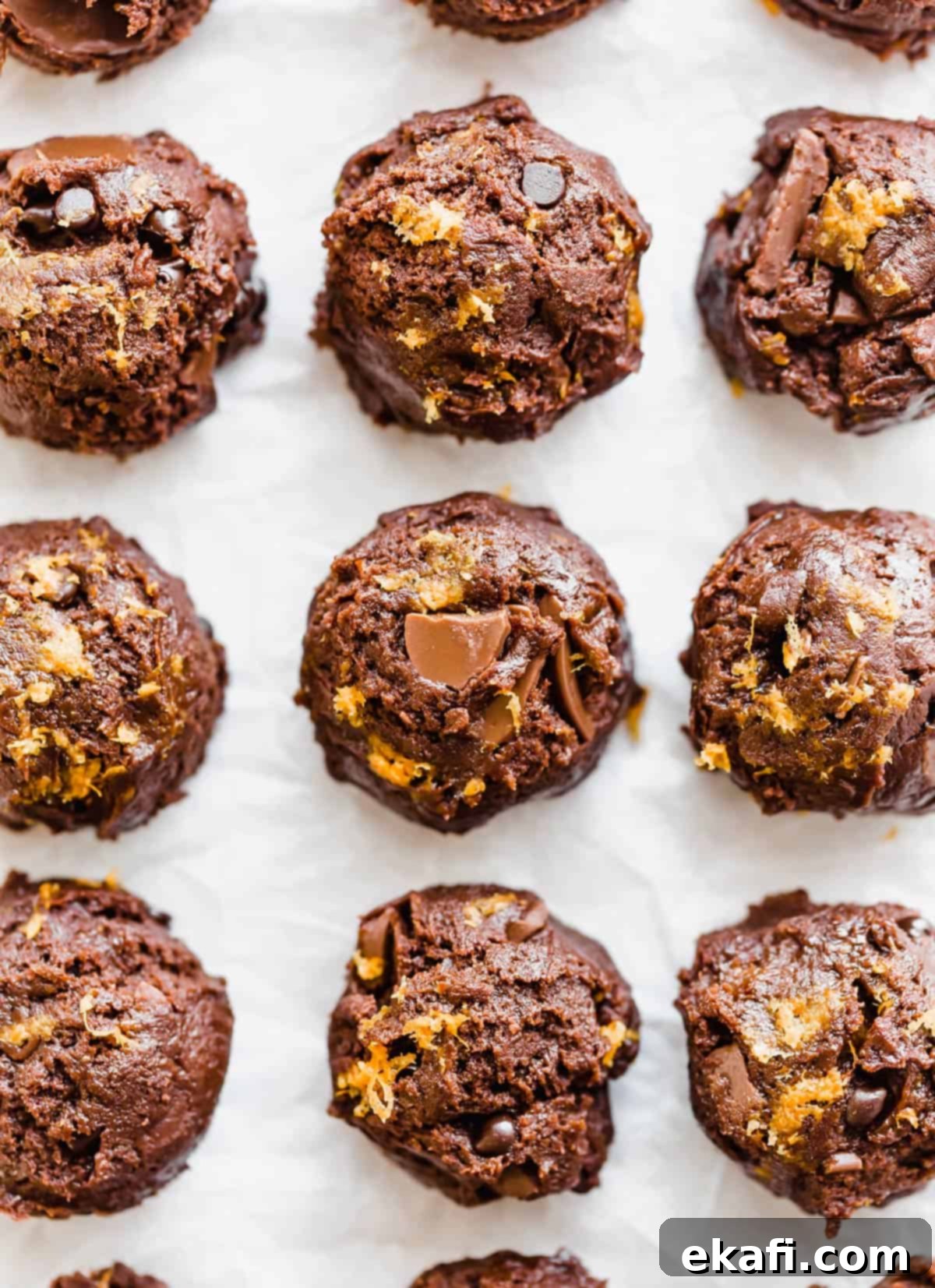Irresistible Chocolate Orange Cookies 6 Chocolate Orange Cookie dough balls on a white background.