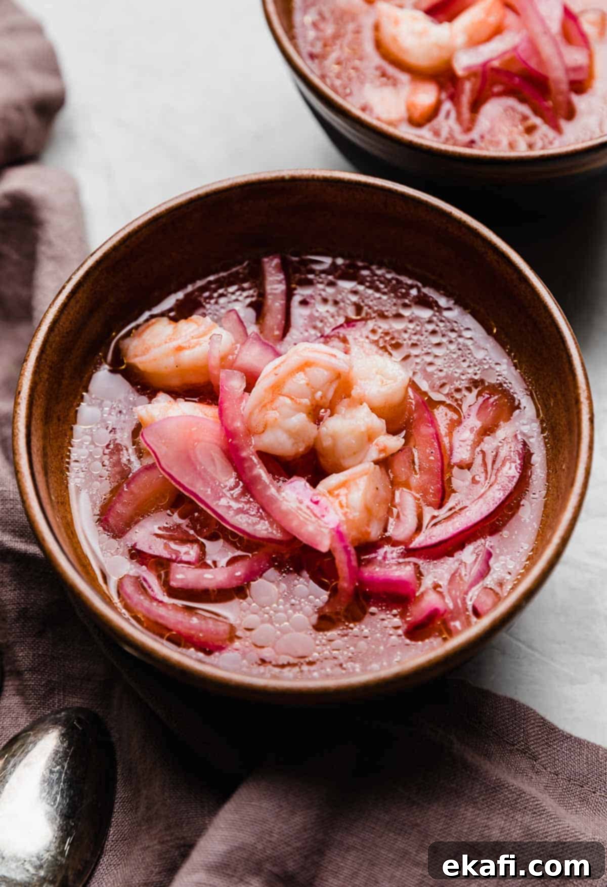 Refreshing Cooked Shrimp Ceviche 2 Shrimp Ceviche with purple onion in a lemon and lime juice mixture.