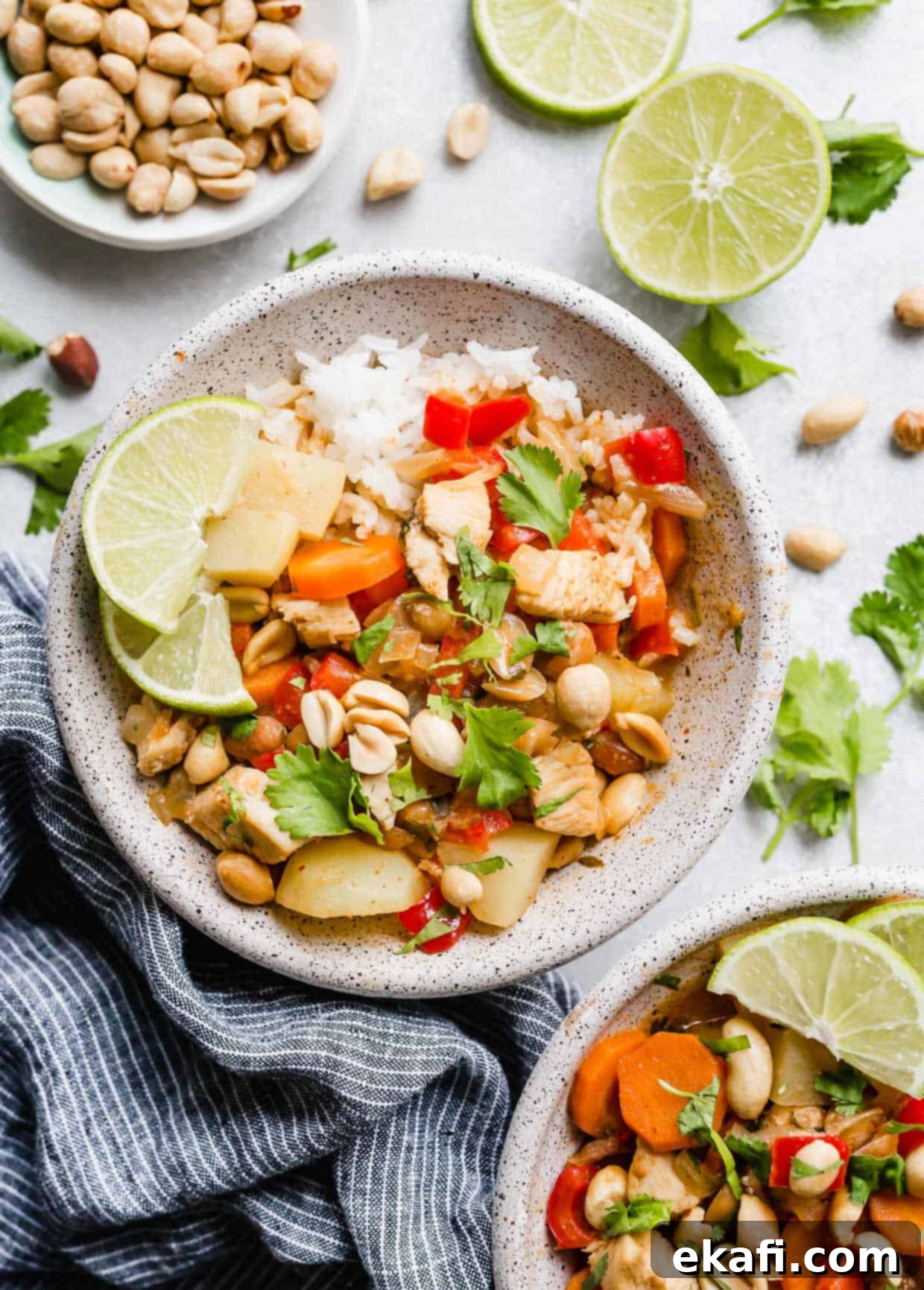 The Royal Massaman Curry 2 A bowl filled with white rice and Massaman Curry topped with cilantro and chopped peanuts.