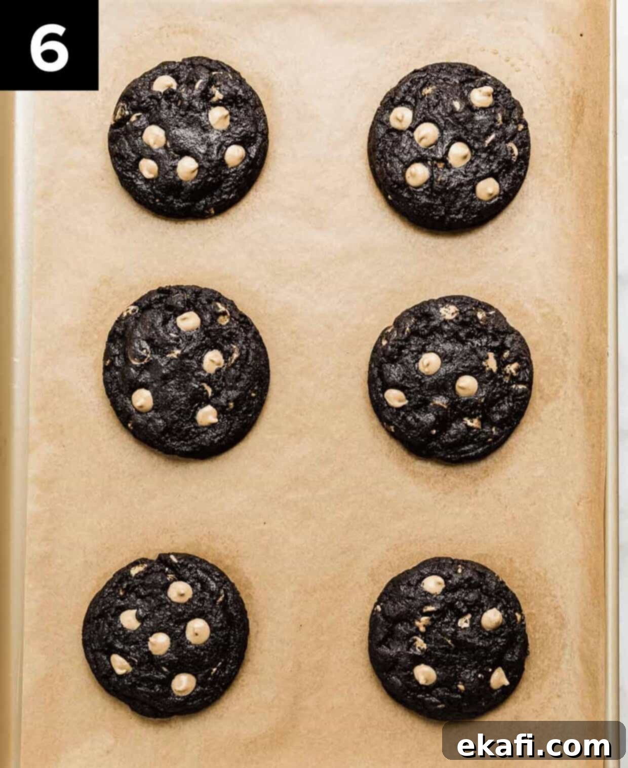 Ultimate Oreo Peanut Butter Cookies 6 Six easy Oreo peanut butter cookies cooling on a parchment-lined baking sheet after baking.