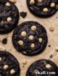 Ultimate Oreo Peanut Butter Cookies 8 Overhead photo of Peanut Butter Oreo Cookies studded with peanut butter chips on a Kraft parchment paper.