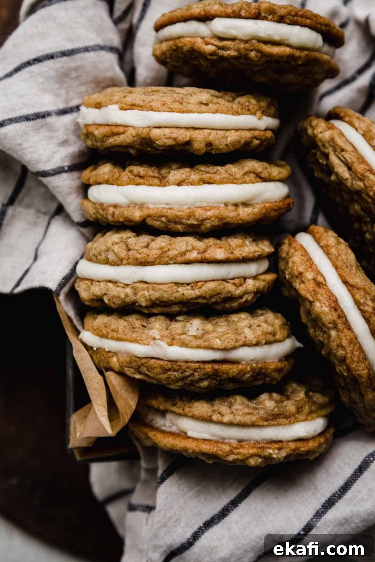 Soft Chewy Oatmeal Cream Sandwiches 6 Oatmeal cream pie cookies sandwiched together with a white frosting, stacked on top of each other, highlighting the perfect assembly.