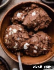 Easy Homemade Rocky Road Ice Cream 10 3 scoops of mini marshmallow and toasted almonds mixed into a chocolate custard ice cream base (rocky road ice cream), scooped into a brown bowl.