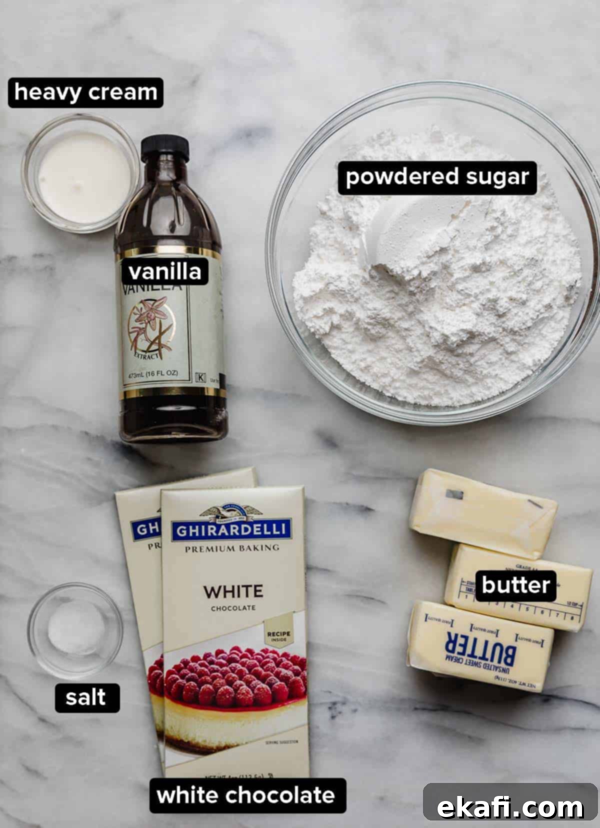Luscious White Chocolate Frosting 3 A neat arrangement of White Chocolate Buttercream Frosting ingredients: powdered sugar, white chocolate bars, softened butter, a pinch of salt, vanilla extract, and a small jug of heavy cream, all on a pristine white surface.
