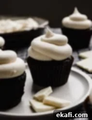 Luscious White Chocolate Frosting 8 White Chocolate Buttercream Frosting swirled beautifully on top of an Oreo cupcake, showcasing the recipe's perfect result.