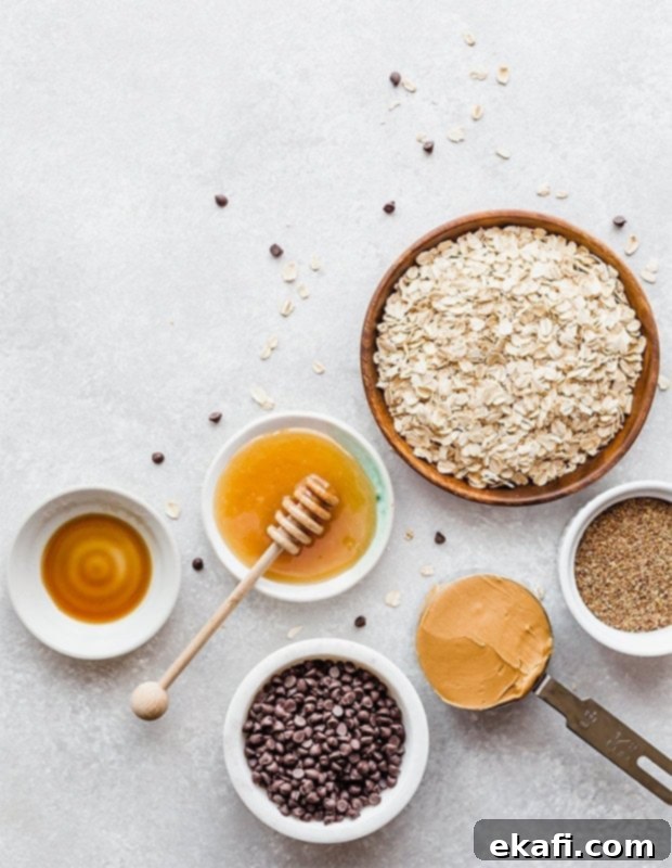 Effortless Power Bites 3 Overhead view of the ingredients needed to make no-bake energy bites; honey, oats, flax seed, peanut butter, chocolate chips, and vanilla.
