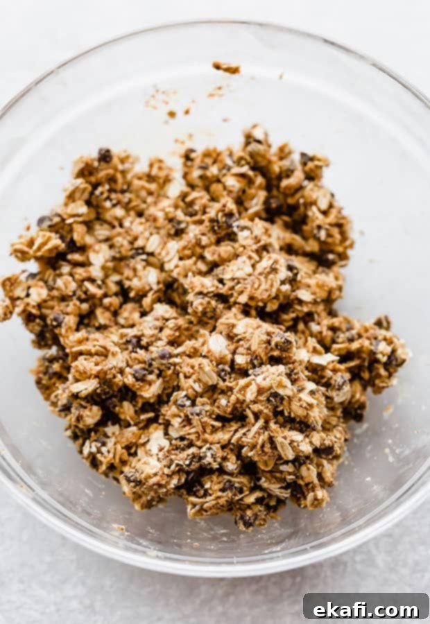 Effortless Power Bites 5 A glass bowl with no-bake energy bites ingredients mixed together.