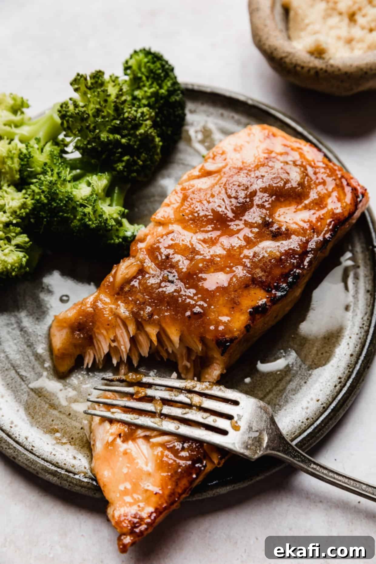 Caramelized Brown Sugar Salmon 7 A beautiful plate of brown sugar glazed salmon, perfectly seared and garnished, set against a pristine white background, ready to be enjoyed.