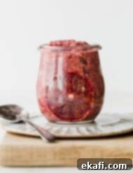 Zesty Blood Orange Chia Pudding 5 A glass jar filled with Blood Orange Chia Pudding, against a white background.