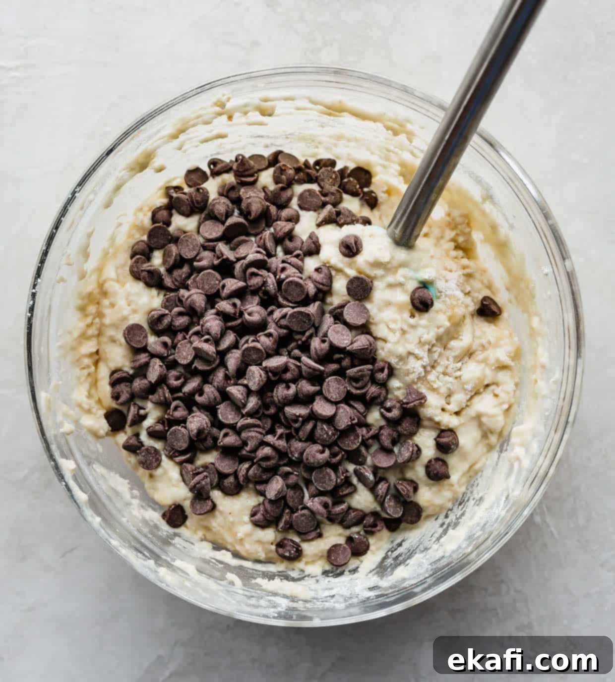 Velvet Banana Chocolate Chip Muffins 5 Buttermilk Banana Chocolate Chip Muffin batter in a glass bowl.