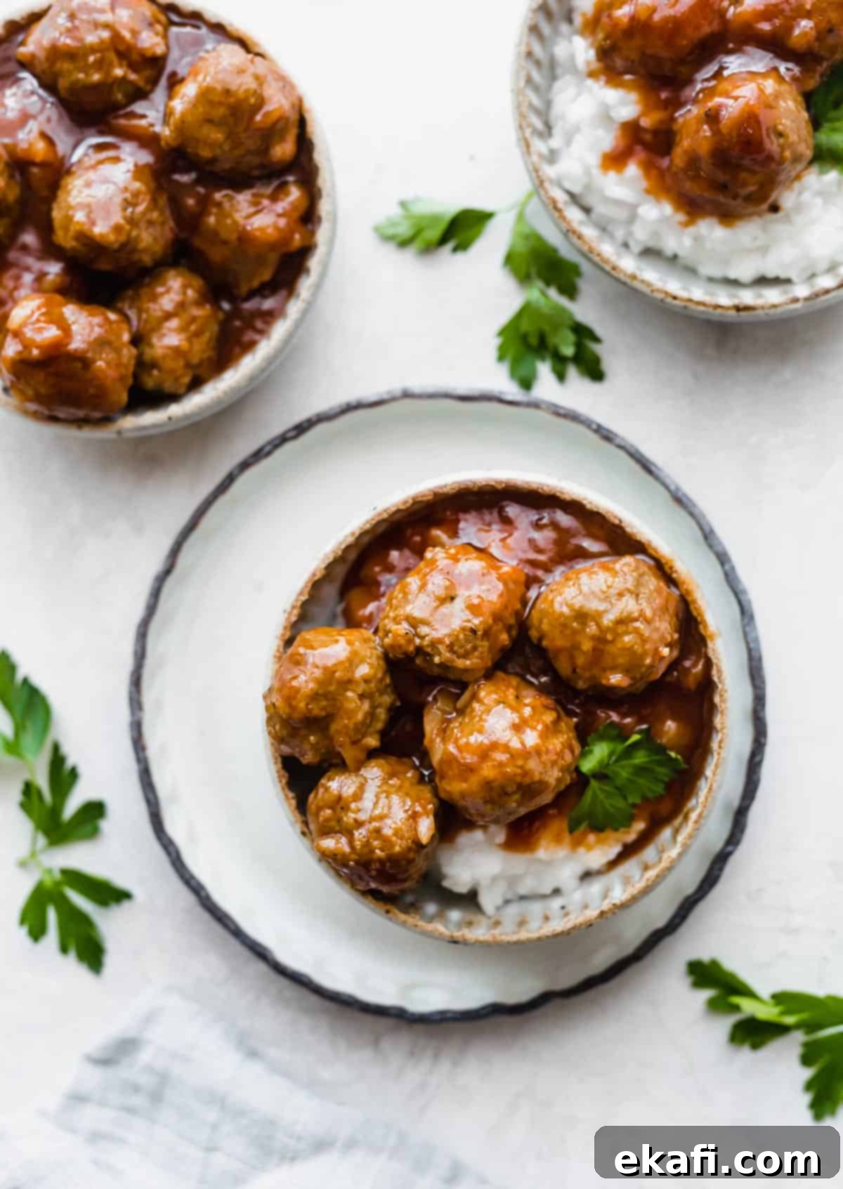 Sticky Pineapple BBQ Meatballs 2 A bowl filled with fluffy white rice, topped generously with glistening BBQ Pineapple Meatballs, served on a clean white background.