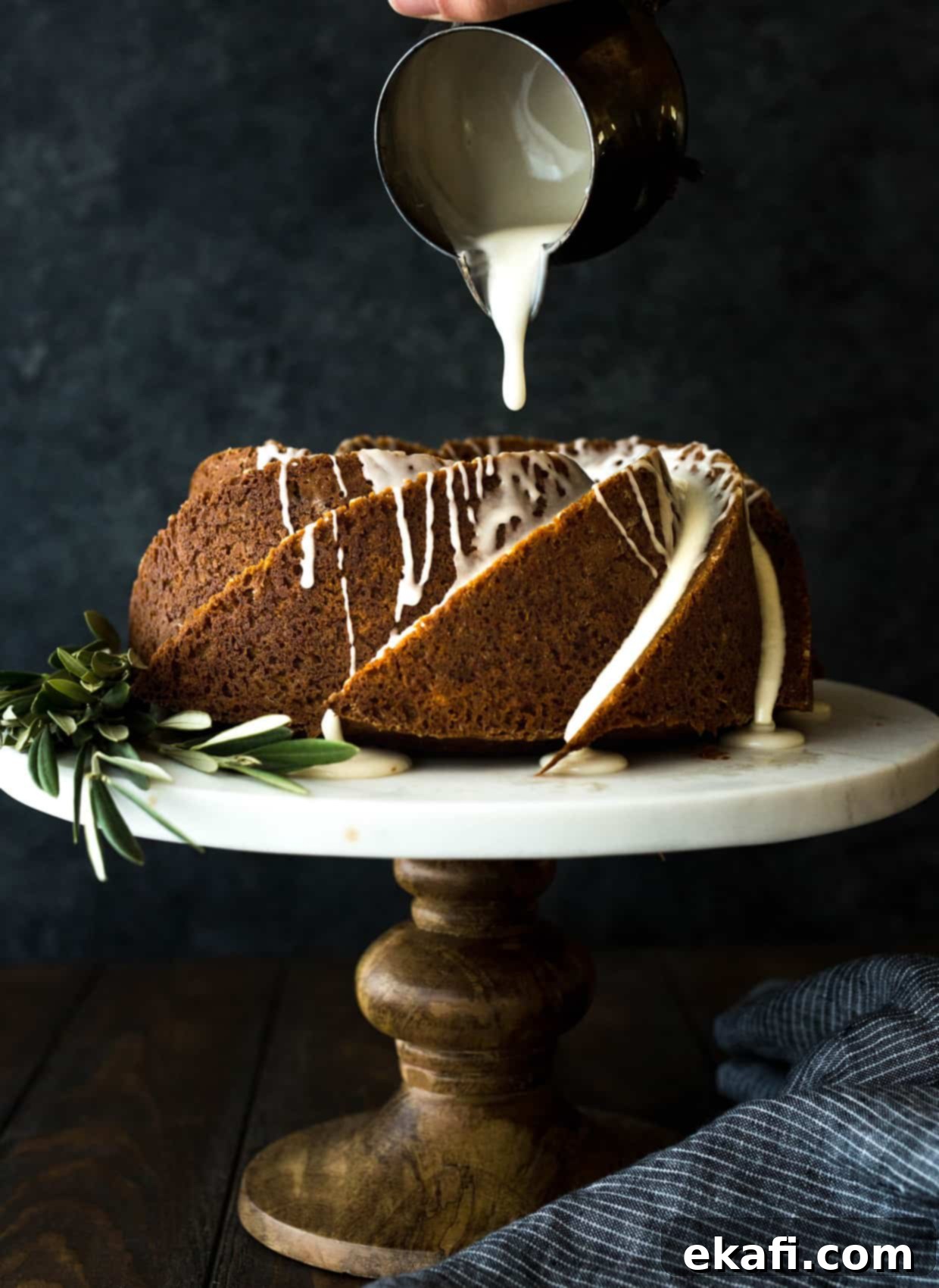 Spiced Gingerbread Bundt Delight 6 Gingerbread bundt cake gracefully sitting on a cake stand, with a rich maple glaze slowly and tantalizingly drizzling down its fluted sides, highlighting its appealing texture.