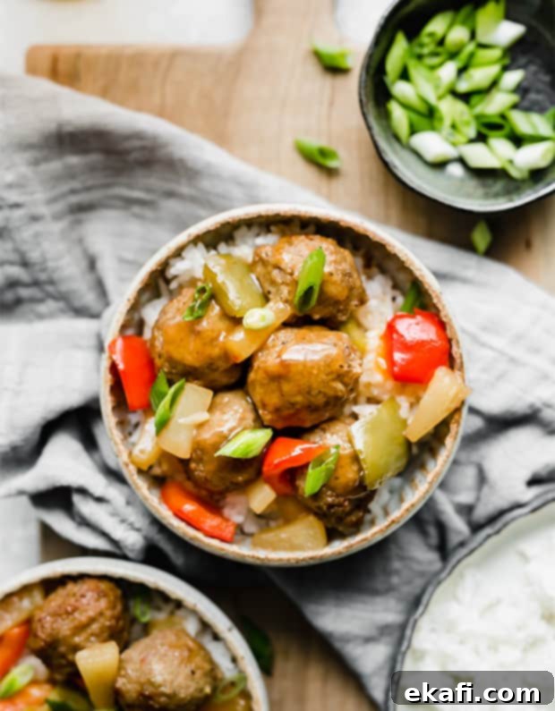 Tangy Sweet Slow Cooker Meatballs 8 A bowl of sweet and sour meatballs topped with green onions.