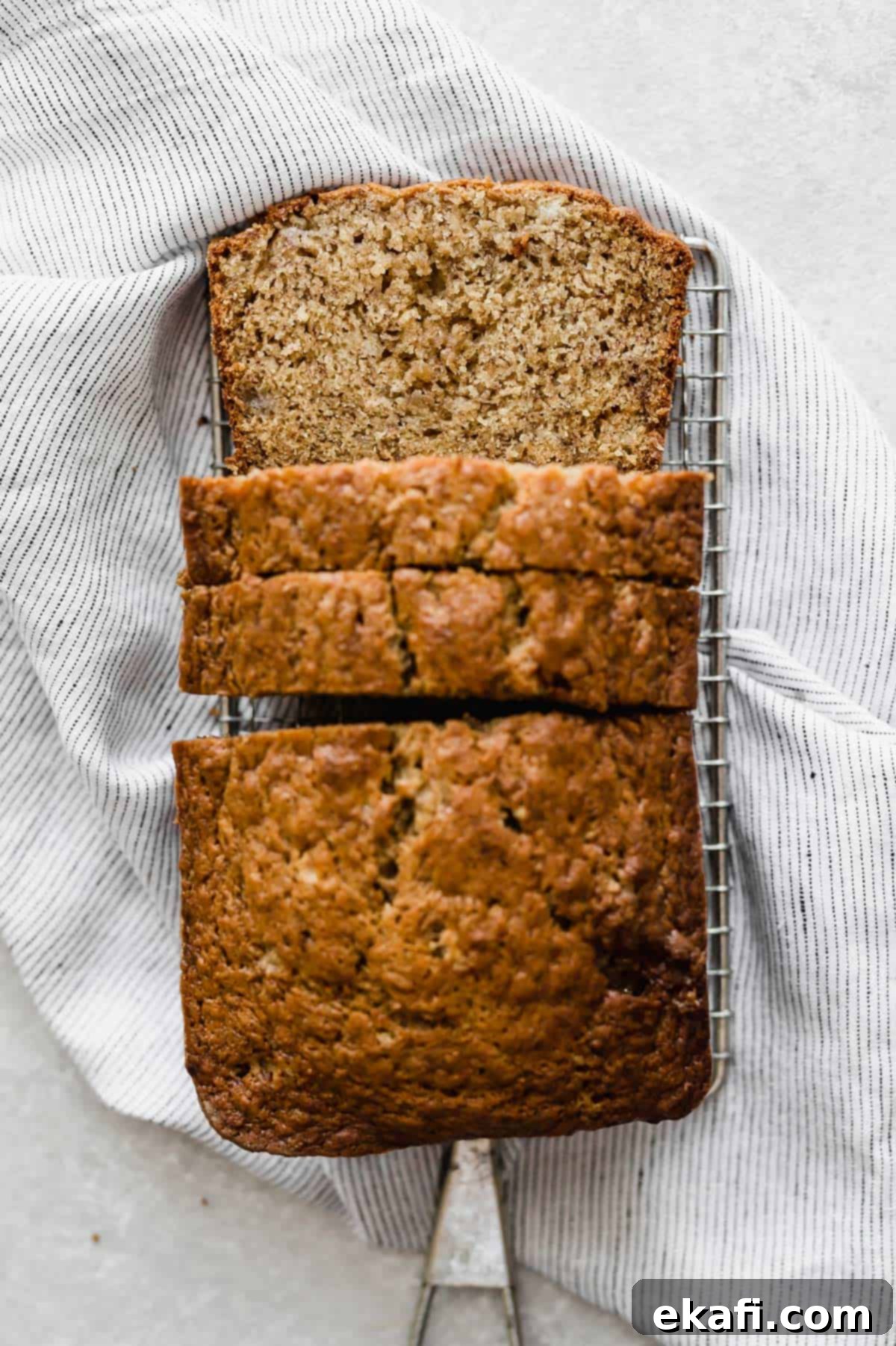Irresistible Cinnamon Swirl Banana Bread 8 A loaf of Banana Bread on a wire rack on a white background.