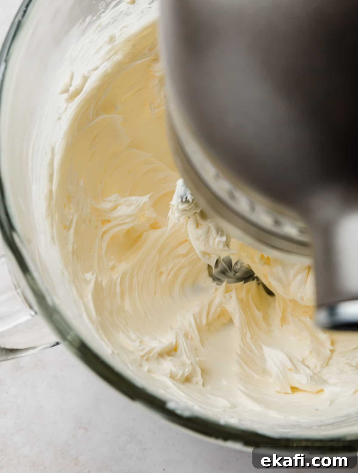 Decadent Chocolate Buttercream 5 Butter being creamed in a stand mixer bowl, turning light and fluffy.
