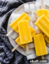 Sun-Kissed Pineapple Mango Pops 9 A pile of pineapple mango popsicles.