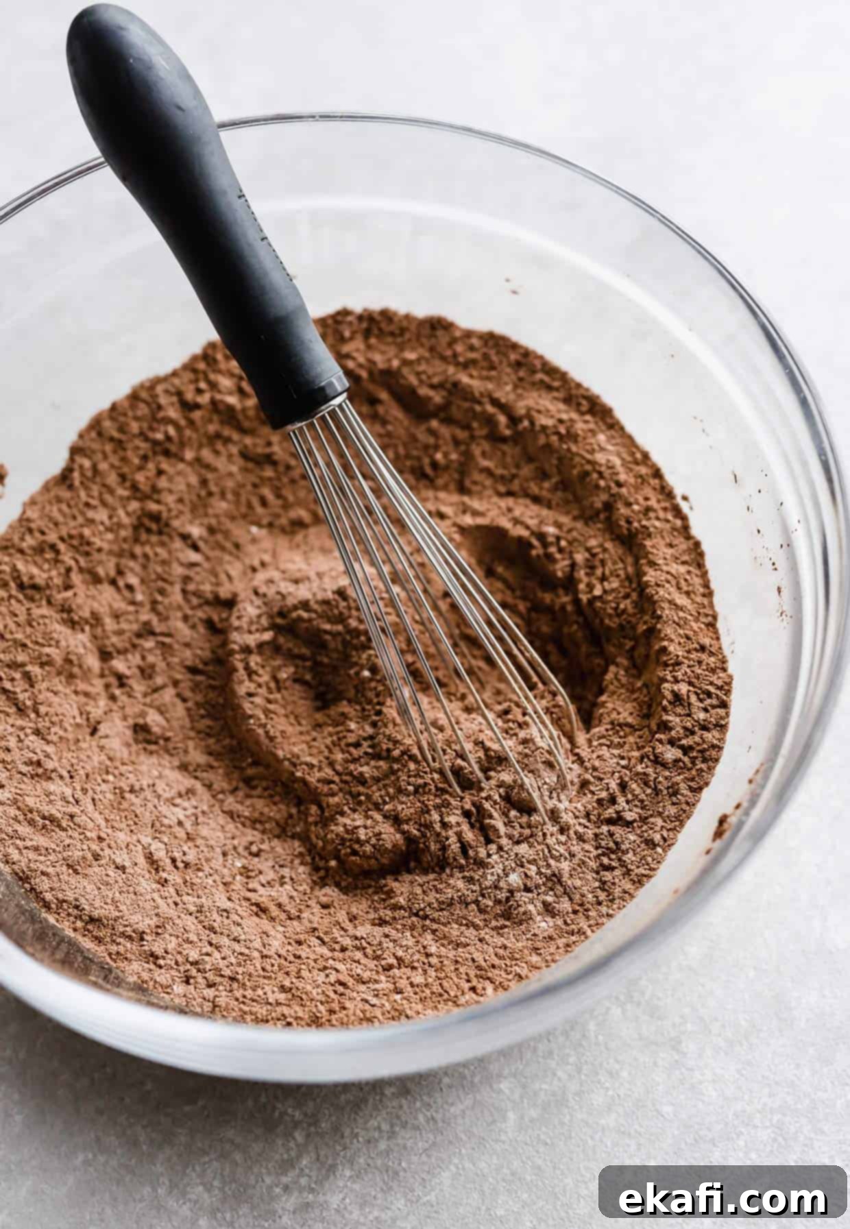 Irresistibly Rich Chocolate Cupcakes 4 A glass bowl with dark brown flour mixture in it.