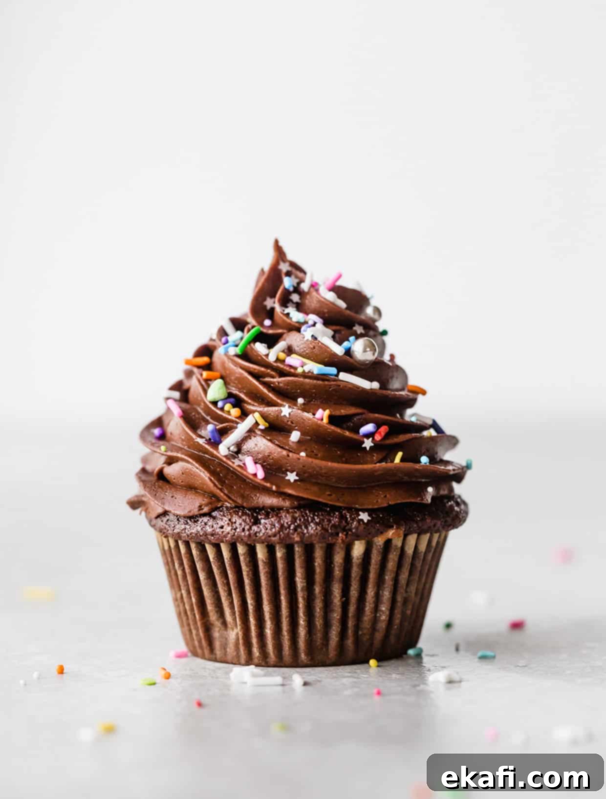 Irresistibly Rich Chocolate Cupcakes 8 A single chocolate cupcake topped with a swirl of chocolate frosting and colorful sprinkles.