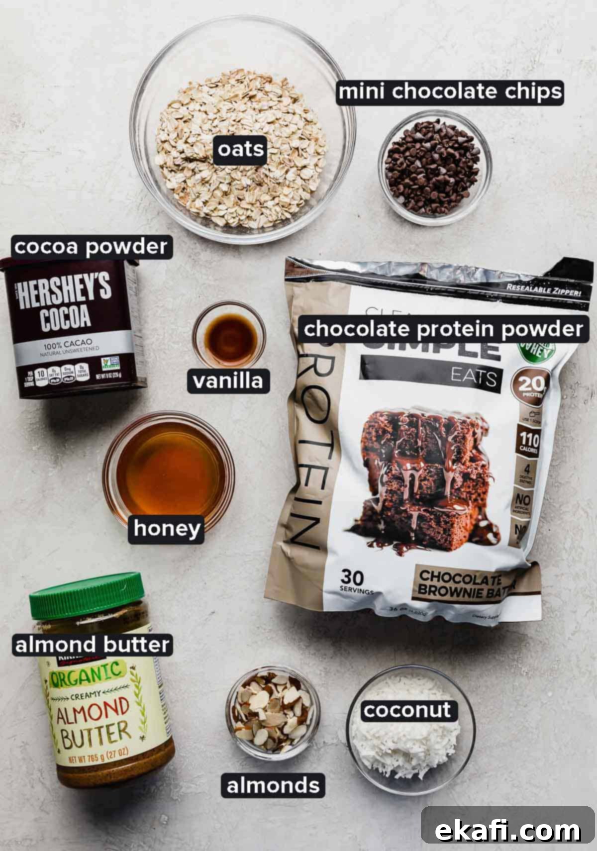 Μπάλες Πρωτεΐνης με Αμύγδαλο Joy 3 Almond Joy Protein Ball ingredients on a white background, ingredients include: chocolate protein powder, honey, almond butter, almonds, oats, coconut.