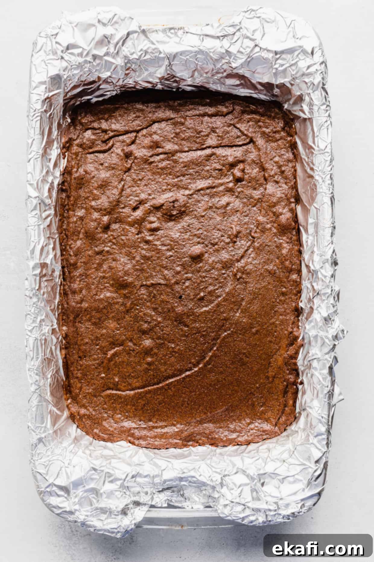 Stardust Brownies 11 Freshly baked Cosmic Brownies in a foil-lined baking dish, showing a slightly crinkly top crust.